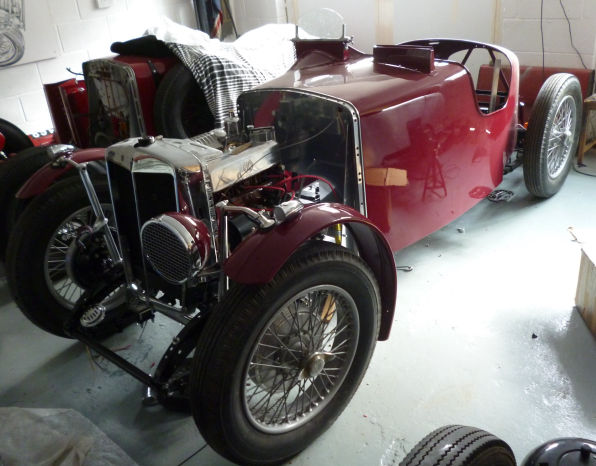 The car in the workshop after painting, radiator grille and wings fitted.