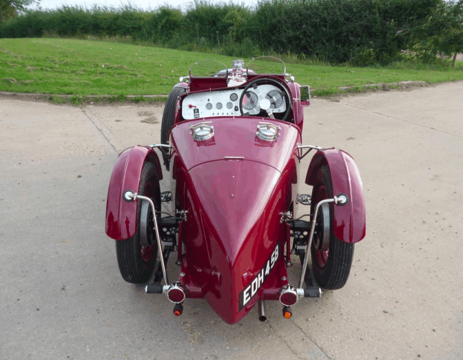 View from directly behind: the tapered tail, rear plate EDH 458, cycle wings and the dashboard beyond.